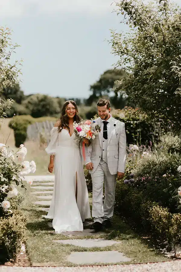 Wedding Couple Walking Down Garden Path