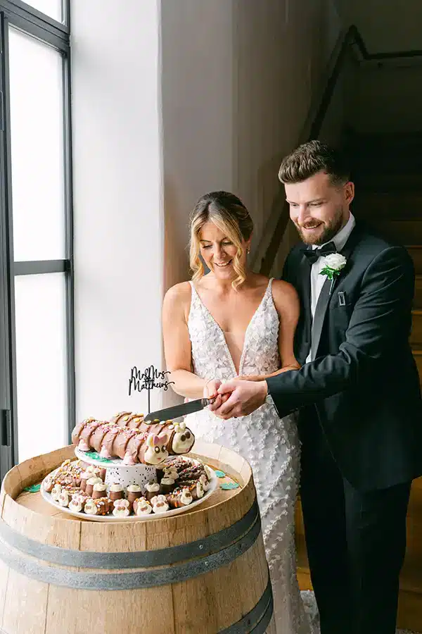 Barn Wedding Couple Cake Cutting