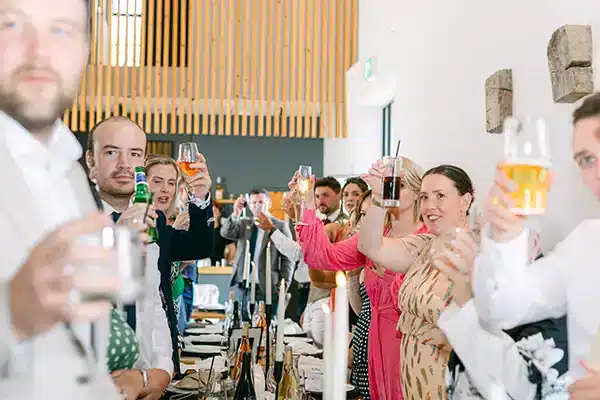 Barn Wedding Venue Guests Toasting Couple